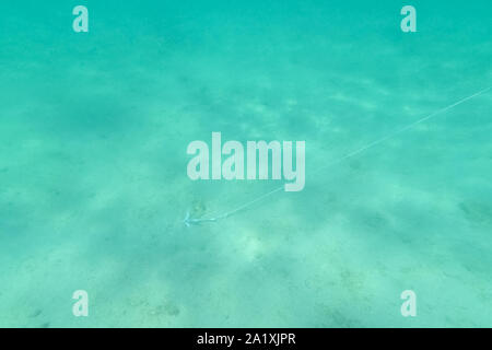 beach perfect white sand turquoise water, reflecting from sun Stock Photo