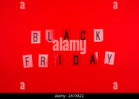 Black Friday sale tag on red background. Stock Photo