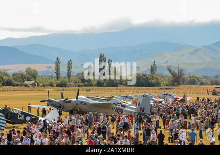 Airshow crowd at Wings over Wairarapa air show at Hood Aerodrome, Masterton, Wairarapa, New Zealand. Countryside, hills, people and aircraft. Tourism Stock Photo