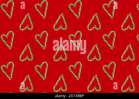 Small hearts made of Christmas candies on red. Seamless pattern. Wrapping paper concept, wallpaper, fabric pattern. Stock Photo