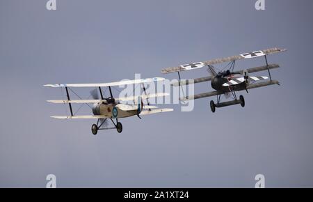 Great War Display Team - Sopwith Triplane and Fokker Dr1 Triplane performing a WW1 Dogfight reenactment at the 2019 Battle of Britain Duxford Airshow Stock Photo