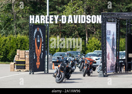 Harley-Davidson text logo above test ride display on a weekend at Canadian Tire Motorsport Park. Stock Photo