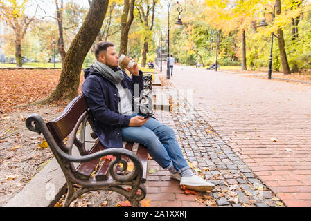 man drinking coffee outdoors autumn season Stock Photo