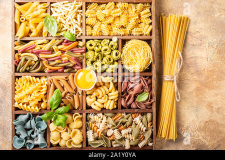 Assorted colorful italian pasta in wooden box Stock Photo