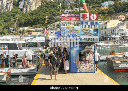 ISLE OF CAPRI, ITALY - AUGUST 2019: People getting off a small boat in the harbour after a trip out to sea from the port on the Isle of Capri Stock Photo