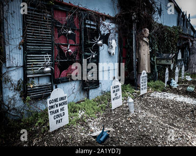 Funny Halloween decorations in front of a haunted house Stock Photo
