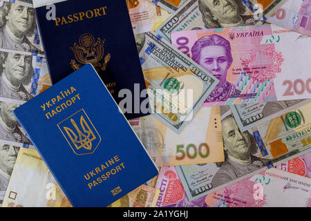 Dual citizens US Passport and ukrainian biometric passpor of US dollar money and ukrainian money hryvnia Stock Photo