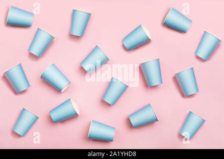 Pattern from mint blue paper drinking cups arranged randomly on pink background. Birthday party celebration abstract fashion baby shower concept. Mini Stock Photo