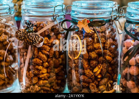 Different types of nuts and seeds in glass jar close up. A variety of nuts in glass jars. Stock Photo