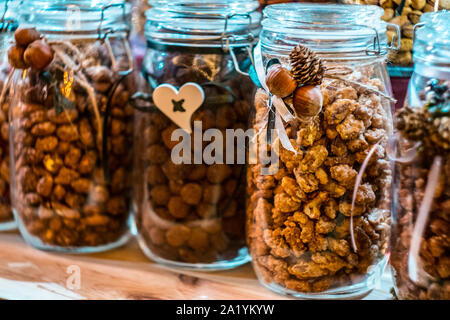 Different types of nuts and seeds in glass jar close up. A variety of nuts in glass jars. Stock Photo