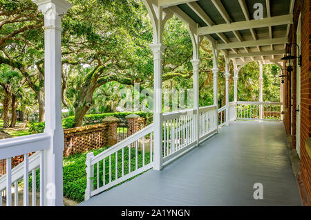 A wide front porch offers a shady place to rest at St. Augustine Lighthouse and Maritime Museum in St. Augustine, Florida. Stock Photo