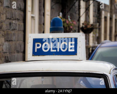 Police sign on top of 1960's car. Stock Photo