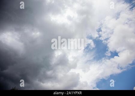 storm clouds rolling across a blue sky before a storm Stock Photo