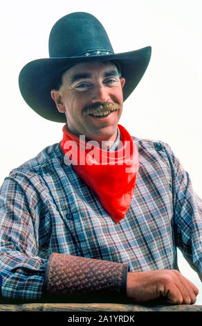 https://l450v.alamy.com/450v/2a1yrdk/a-mustached-wrangler-smiles-while-posing-for-a-picture-before-leading-a-trail-ride-on-horseback-with-guests-at-a-dude-ranch-in-the-southwestern-state-of-arizona-usa-his-cowboy-outfit-includes-a-black-ten-gallon-hat-a-red-bandanna-around-his-neck-a-long-sleeve-plaid-shirt-and-leather-cuffs-to-protect-his-wrists-and-shirtsleeves-the-neckerchief-is-standard-attire-and-cowboys-call-it-by-various-names-like-neck-rag-wild-rag-buckaroo-scarf-and-kerchief-most-common-of-its-many-uses-is-pulling-up-the-cloth-over-the-face-for-protection-against-dust-wind-or-inclement-weather-2a1yrdk.jpg