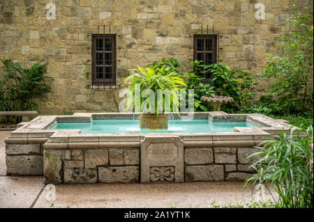 A fountain dedicated to Davy Crockett in the courtyard of The Alamo, San Antonio, Texas. Stock Photo