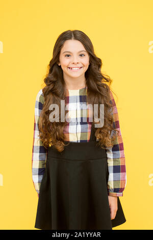 Curve soft curl tong. Curly and happy. Small smiling child curly hairdo. Perfect curly hairstyle. Different shaped curling wands do to your hair. From tightly defined ringlets to loose beachy waves. Stock Photo