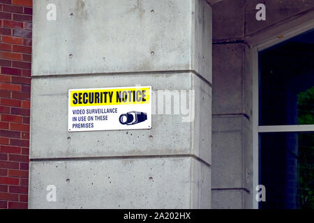 Security Notice "Video Surveillance in Use on These Premises" on cement pillar. Stock Photo