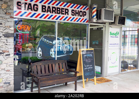 Stag Barber Shop shop window with a chalk board and bench on the sidewalk.  Maple Ridge, British Columbia, Canada. Stock Photo