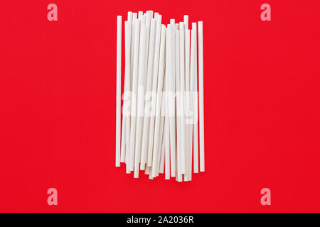paper straws on red background Stock Photo