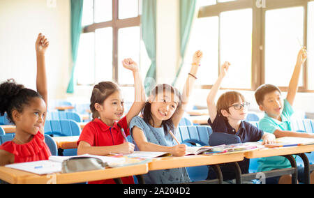 happy elementary school kids  in classroom Stock Photo