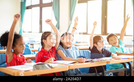 happy elementary school kids  in classroom Stock Photo