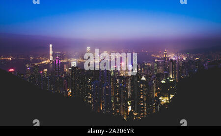 (Filtered picture) View from above, stunning view of the illuminated Hong Kong skyline during a beautiful sunset. Picture taken from the Victoria Peak Stock Photo