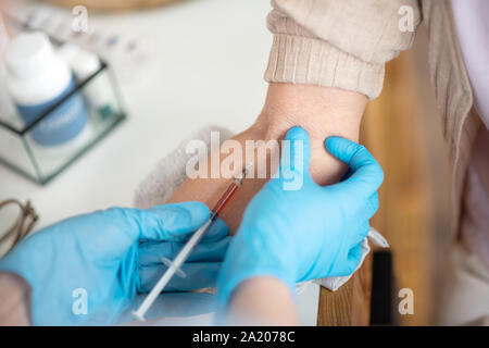 Top view of nurse making injection for retired lady Stock Photo
