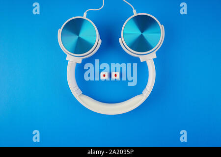 blue white color headphone on a blue background Stock Photo