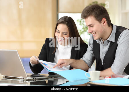 Happy office workers checking statistics on paper documents Stock Photo