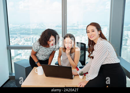 Successful multi-etnic business team working on project together in modern office Stock Photo