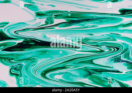 Liquid abstract art. Marble texture of green color. Abstract texture of liquid acrylic. Stock Photo