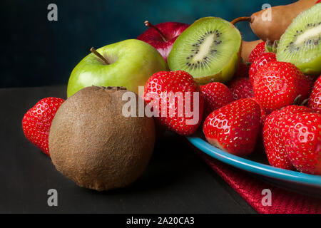 still life fruits on a blue plate and dark blue background in a macro photography concept. Stock Photo