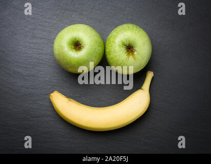 Smiley with fresh fruits on slate stone. Stock Photo