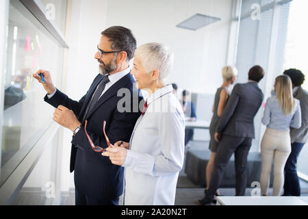 Portrait of happy business people discussing together in office Stock Photo