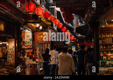Jiufen, Taiwan - November 07, 2018: A young woman walks in the crowd at the Old Street market on November 7, 2018, in Jiufen, Taiwan Stock Photo