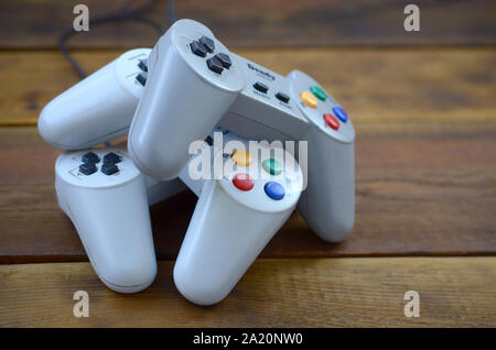 KHARKOV, UKRAINE - SEPTEMBER 18, 2019: Dendy video game console classic controllers on a wooden table. One of the most classic gaming consoles Stock Photo