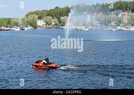 Lappeenranta, Finland - July 27, 2019: Man leaving Lappeenranta harbor with water scooter. Stock Photo