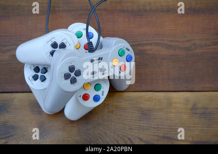 KHARKOV, UKRAINE - SEPTEMBER 18, 2019: Dendy video game console classic controllers on a wooden table. One of the most classic gaming consoles Stock Photo