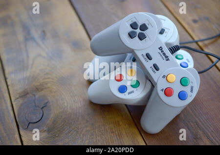 KHARKOV, UKRAINE - SEPTEMBER 18, 2019: Dendy video game console classic controllers on a wooden table. One of the most classic gaming consoles Stock Photo