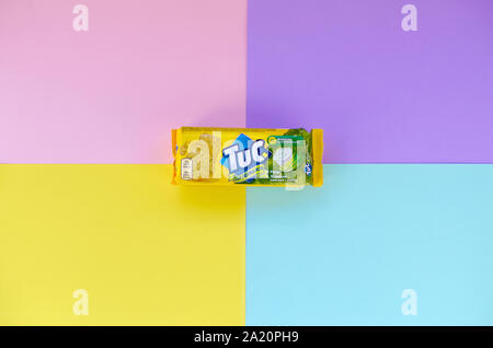 KHARKOV, UKRAINE - SEPTEMBER 23, 2019: Tuc snack pack on bright multi colored flat background. TUC is a brand of snack biscuit marketed by Mondelez In Stock Photo