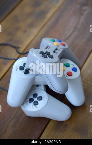 KHARKOV, UKRAINE - SEPTEMBER 18, 2019: Dendy video game console classic controllers on a wooden table. One of the most classic gaming consoles Stock Photo