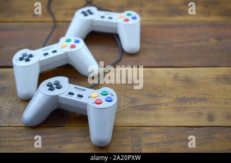 KHARKOV, UKRAINE - SEPTEMBER 18, 2019: Dendy video game console classic controllers on a wooden table. One of the most classic gaming consoles Stock Photo