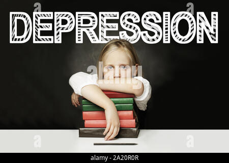 Tired child with books. Depression concept Stock Photo