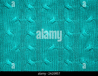 Knitted texture of turquoise color. Background for a holiday card. Close-up. Stock Photo