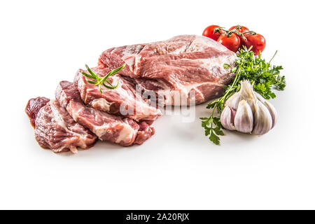 Pork neck raw meat with garlic parsley herbs tomatoes and rosemary isolated on white background Stock Photo