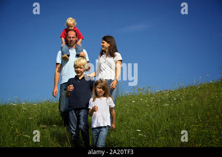 Family walking in field Stock Photo