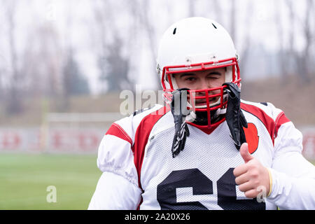 portrait of young confident American football player standing on the field during training Stock Photo