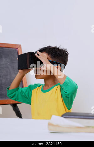 Excited kid using e-learning with VR glasses Stock Photo