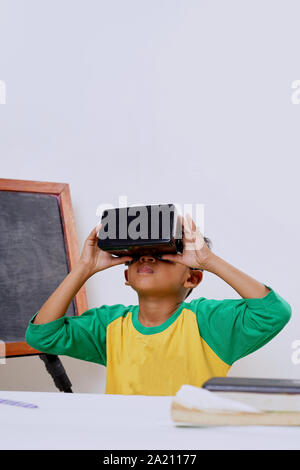 Excited kid using e-learning with VR glasses Stock Photo