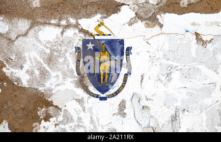 Massachusetts grunge, damaged, scratch, old style state flag on wall. Stock Photo